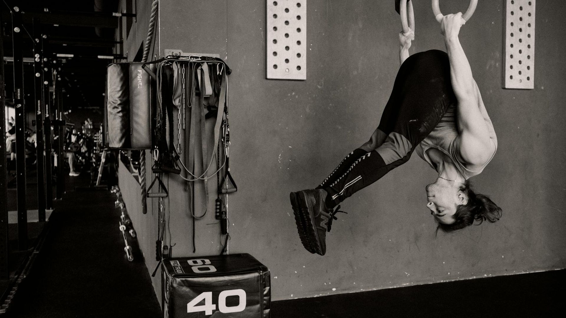 Athletic man performing strength exercises in a dark gym