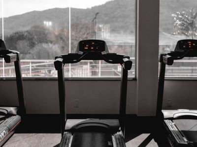 Moody gym lighting with exercise equipment shadows